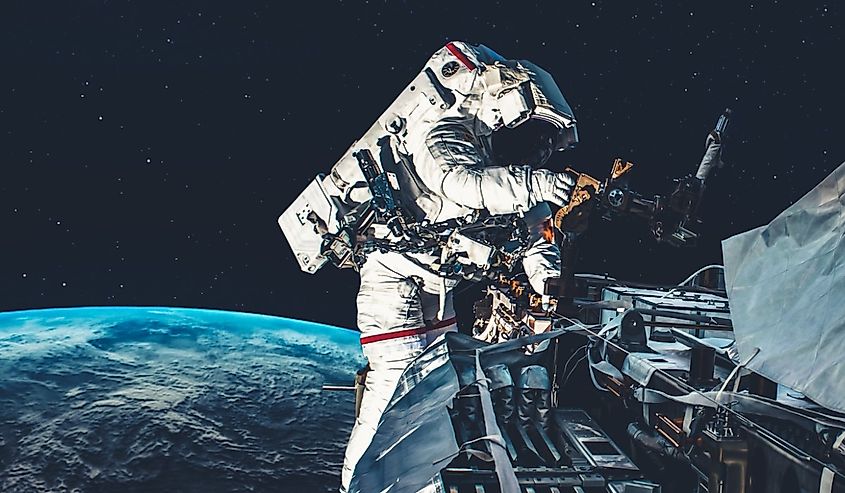 Astronaut spaceman do spacewalk while working for spaceflight mission at space station.