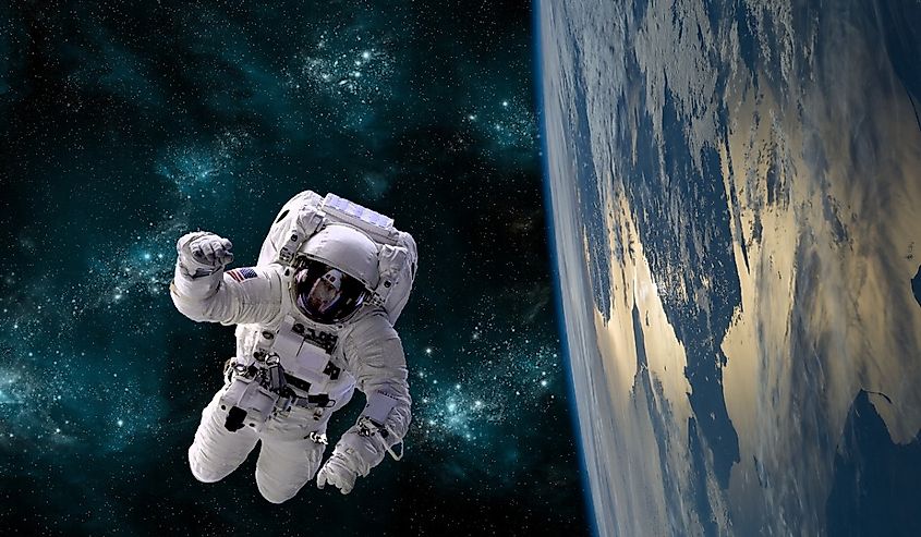 An astronaut floats above Earth.