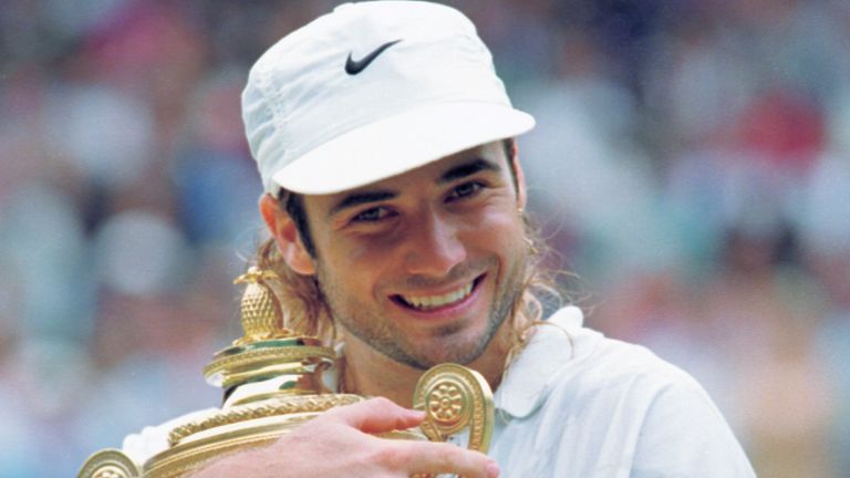 Andre Agassi hugs his trophy after defeating Goran Ivanisevic to win the men's singles final on the Centre Court at Wimbledon Sunday, July 5