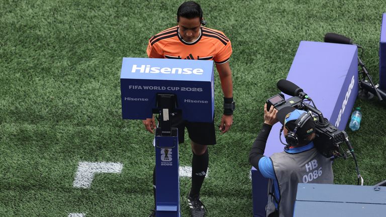Referee Said Martinez checks the VAR for a Belgium penalty against Senegal