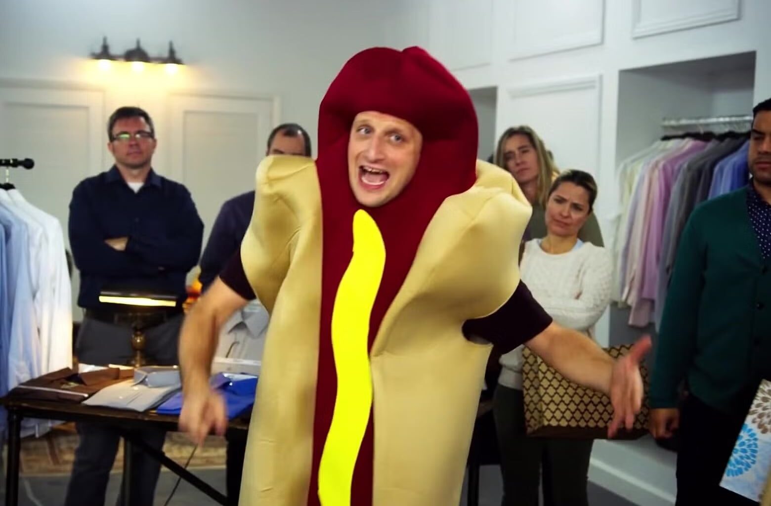 A man wears a hot dog costume.