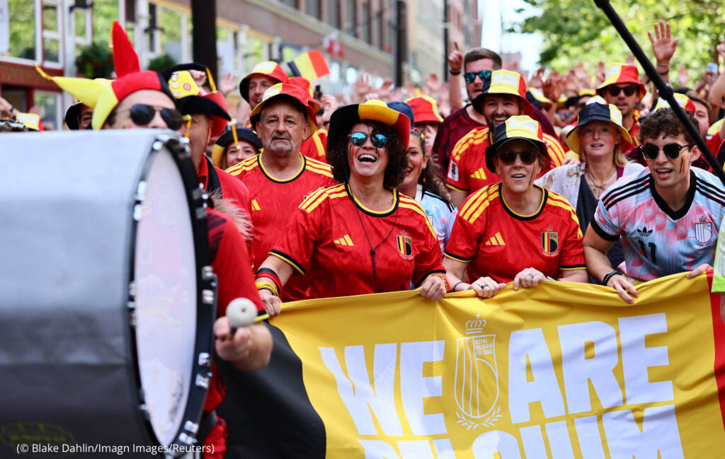 Belgium fans marching and cheering in street (© Blake Dahlin/Imagn Images/Reuters)