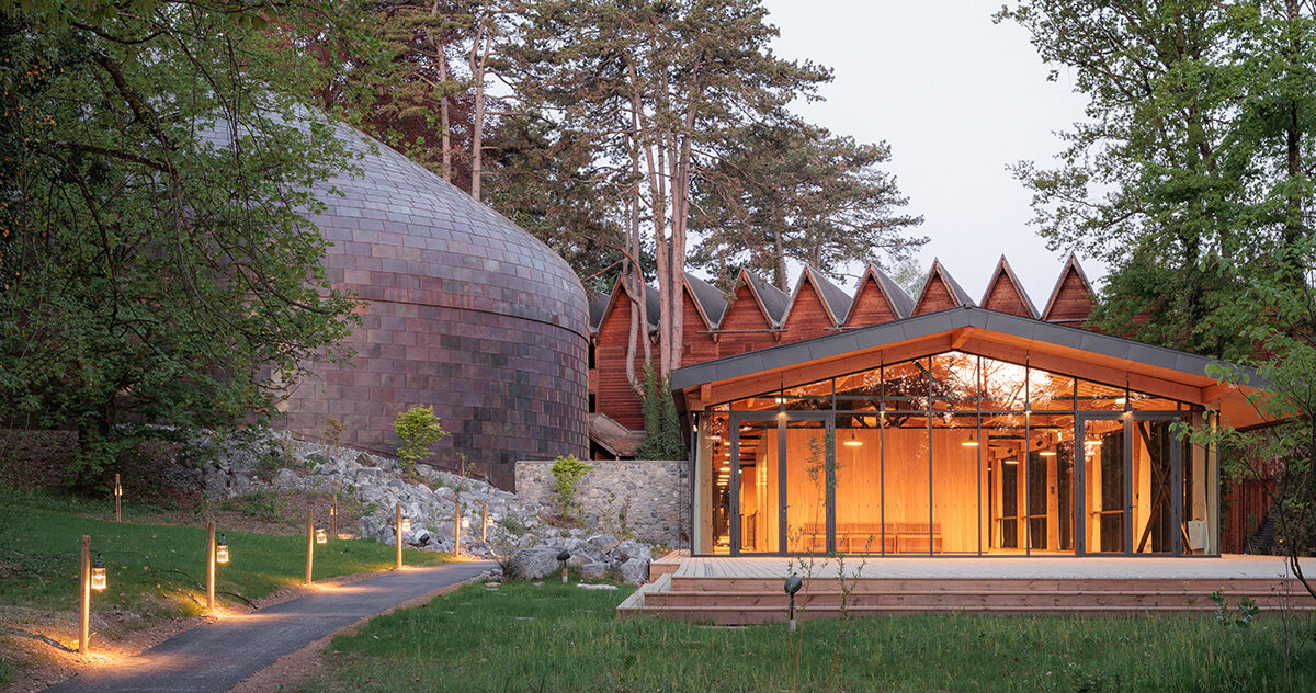 copper shingles wrap curving concert hall in évian, france
