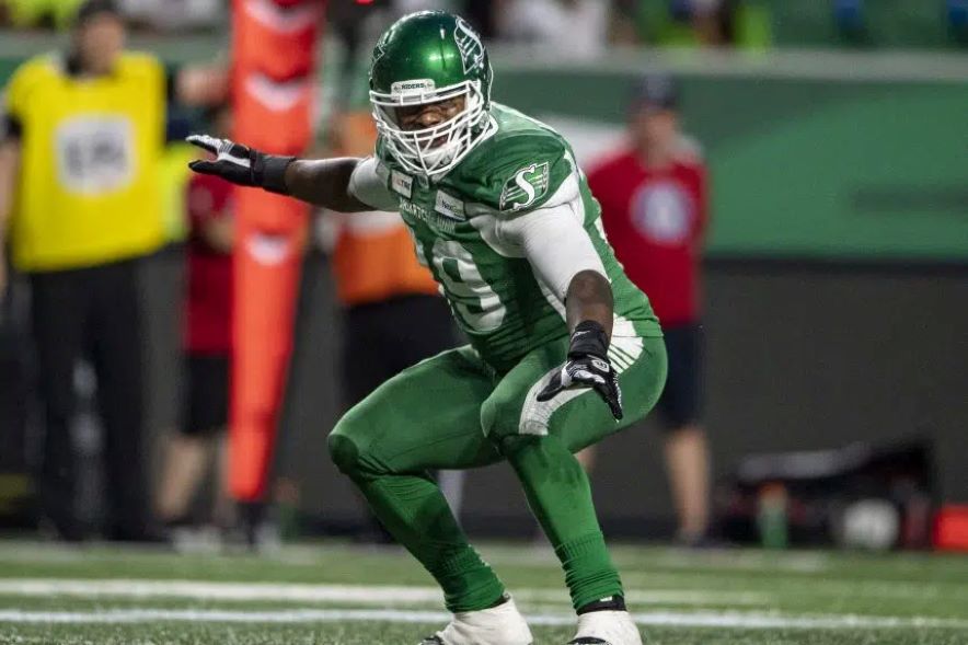 Charleston Hughes strikes a surfing pose on the field with the Saskatchewan Roughriders.