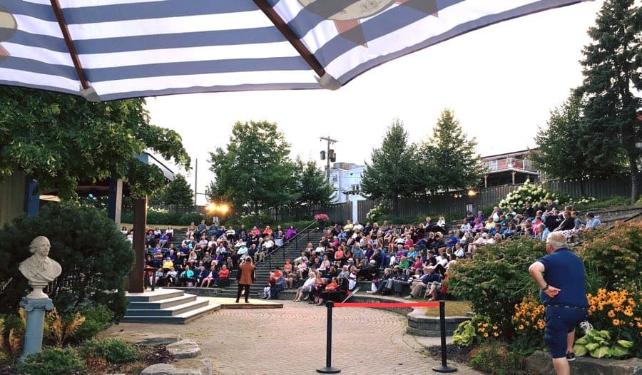 people sitting around a small outdoor amphitheatre