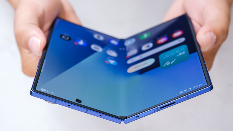 A person holding a half-unfolded Samsung Galaxy Fold7