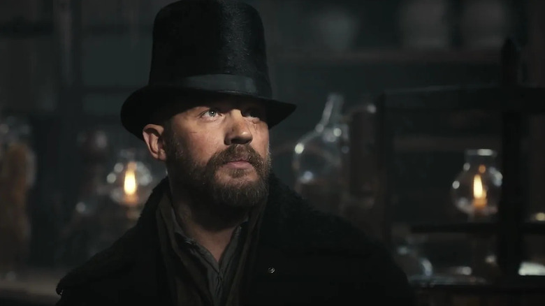 Tom Hardy as James Delaney looking up in shadow in Taboo.