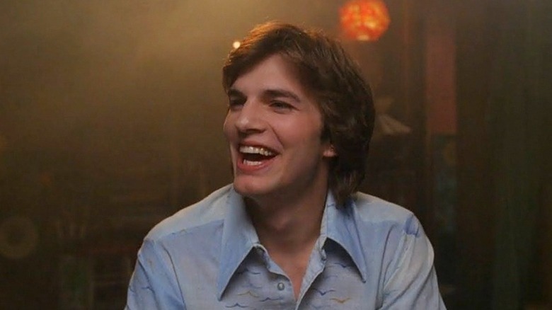 Michael Kelso (Ashton Kutcher) laughs in a smoky basement in That '70s Show