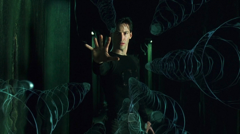 Keanu Reeves as Neo slowing down bullets in The Matrix