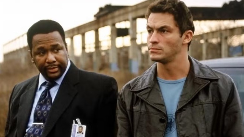Det. James McNulty working a case outside with Det. William Moreland in The Wire