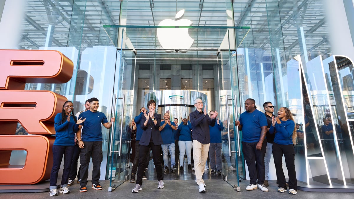 Apple CEO Tim cook standing outside of an Apple store.