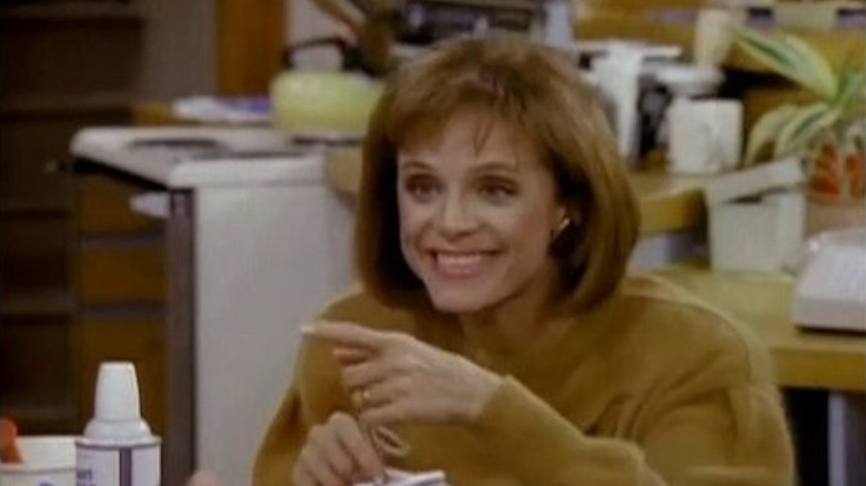 Valerie Harper as Valerie Hogan smiling in mustard-yellow sweater