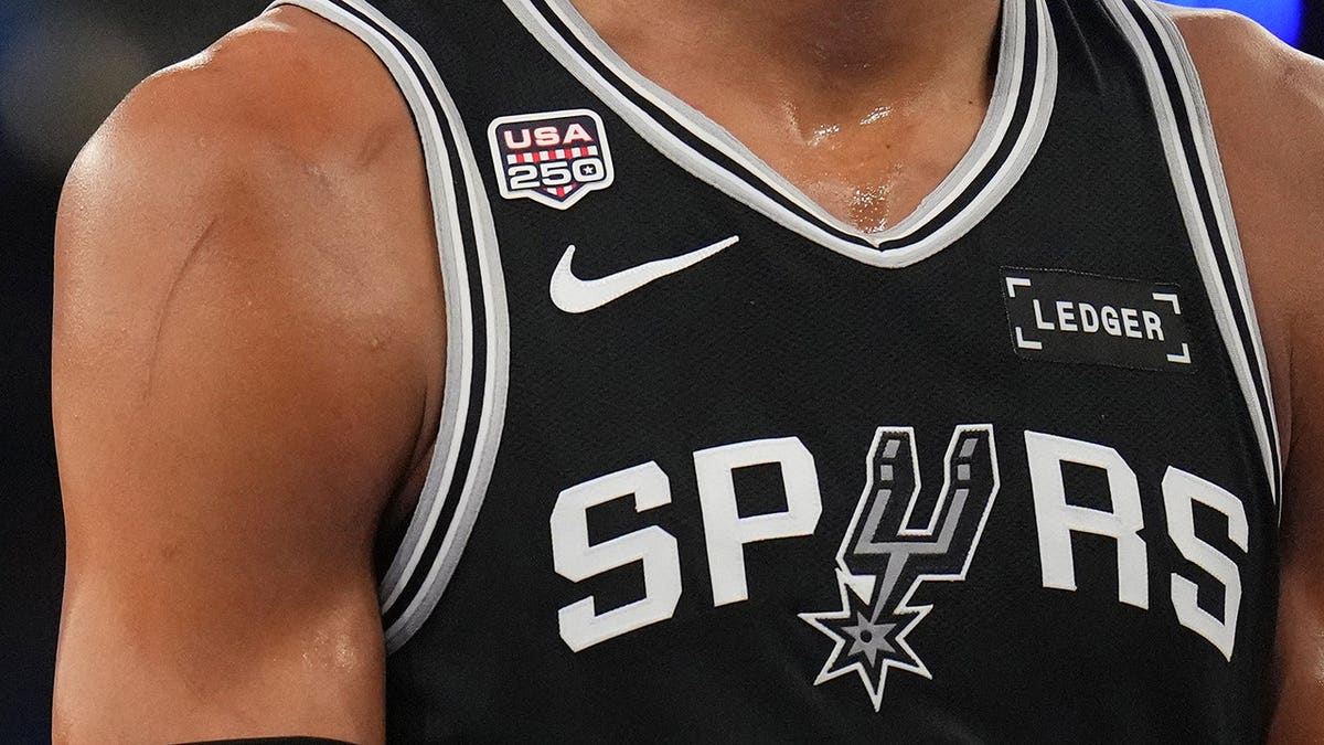 Victor Wembanyama wears an America 250 patch during a game.