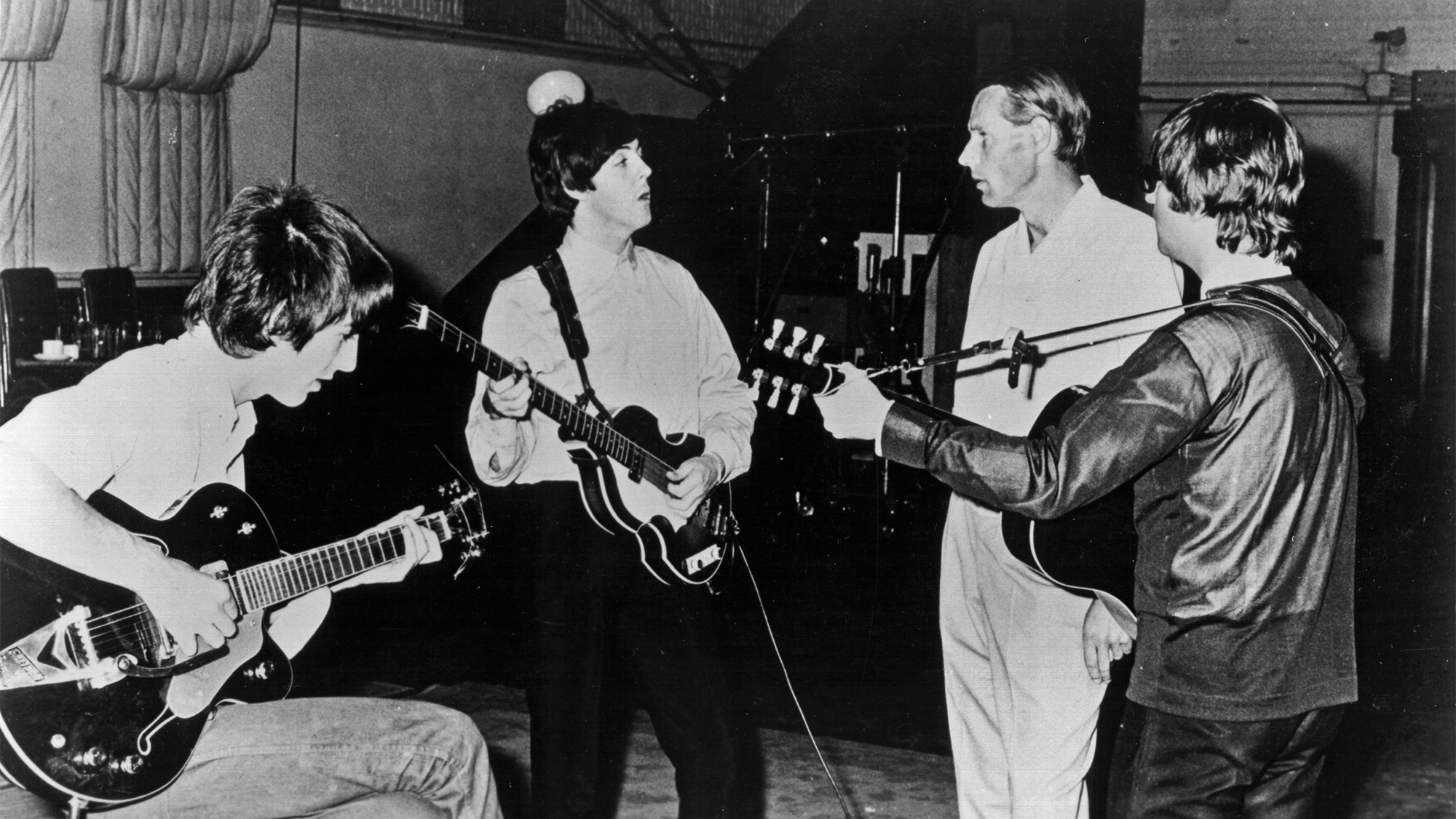 Rock and roll band "The Beatles" pose for a portrait in the studio with their producer George Martin in circa 1964. (L-R) George Harrison, Paul McCartney, George Martin, John Lennon.
