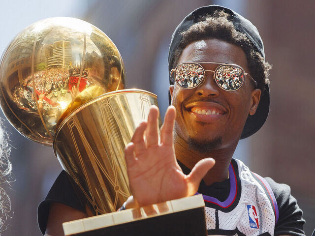 TORONTO, ON - JUNE 17: Kyle Lowry #7 of the Toronto Raptors holds the Larry O'Brien Championship Trophy on the team bus during the Toronto Raptors Championship Victory Parade on June 17, 2019 in Toronto, Ontario. NOTE TO USER: User expressly acknowledges and agrees that, by downloading and/or using this photograph, user is consenting to the terms and conditions of Getty Images License Agreement. Mandatory Copyright Notice: Copyright 2019 NBAE