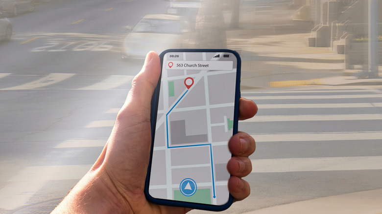 A person using a concept navigation app on a smartphone for walking directions.