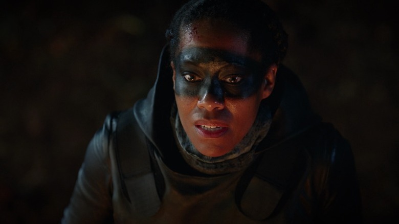 Angela in costume and face paint as Sister Night with a stunned expression on Watchmen S1E1