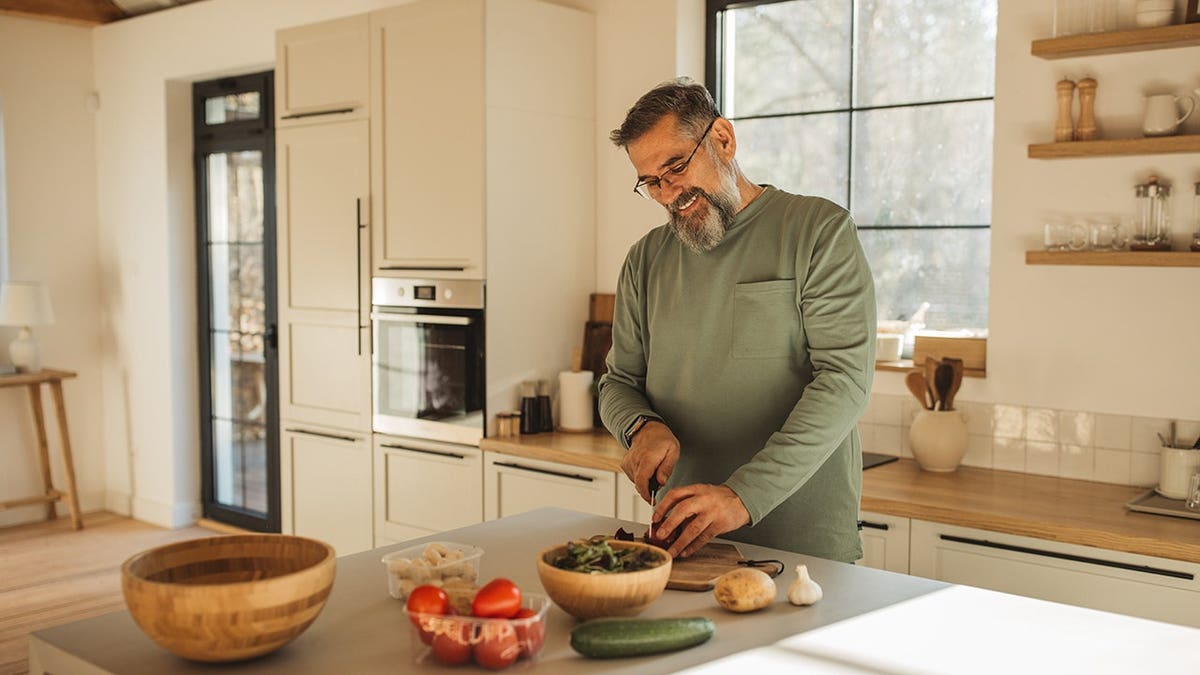 Man cooks breakfast in a home kitchen.