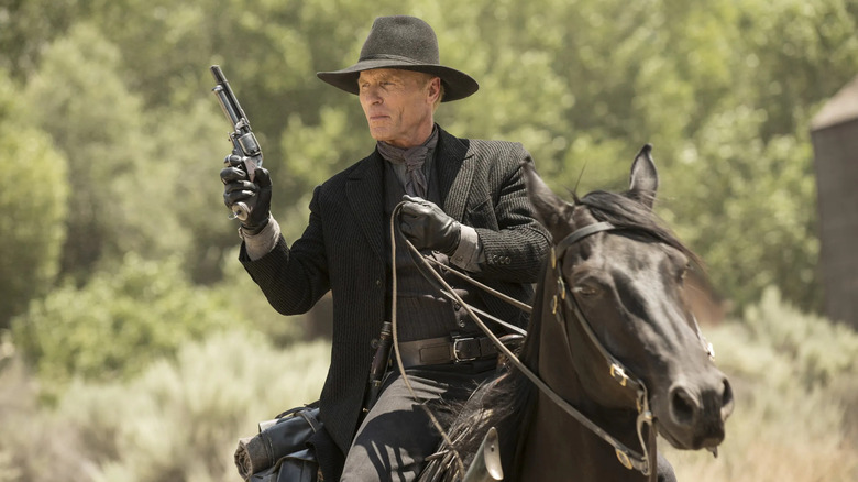 Ed Harris as The Man in Black, wielding a pistol on horseback in Westworld.