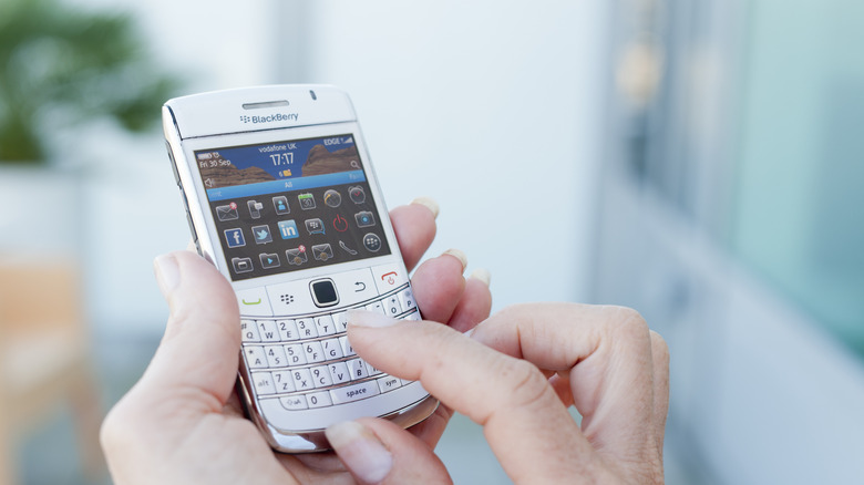 A person using a BlackBerry phone