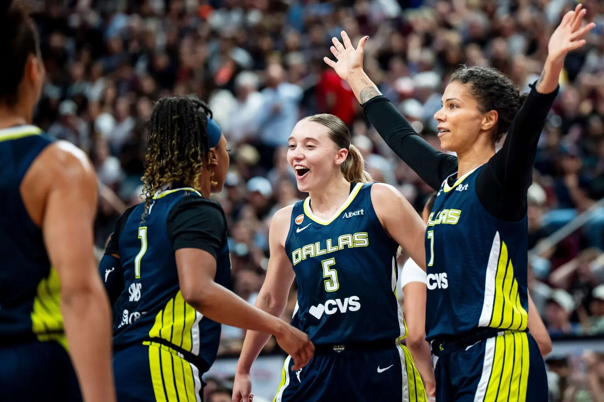 Dallas Wings' Paige Bueckers (5) celebrates with teammates Odyssey Sims (1) and Alysha Clark (7) during the second half of a WNBA basketball game against Toronto Tempo, in Montreal on Friday, July 10, 2026. (Christopher Katsarov/The Canadian Press via AP) Wings Tempo Basketball