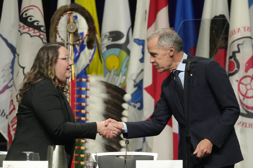Prime Minister Mark Carney shakes hands with AFN National Chief Cindy Woodhouse Nepinak following his speech at the Assembly of First Nations Special Chiefs Assembly in Ottawa on Tuesday, Dec. 2, 2025.