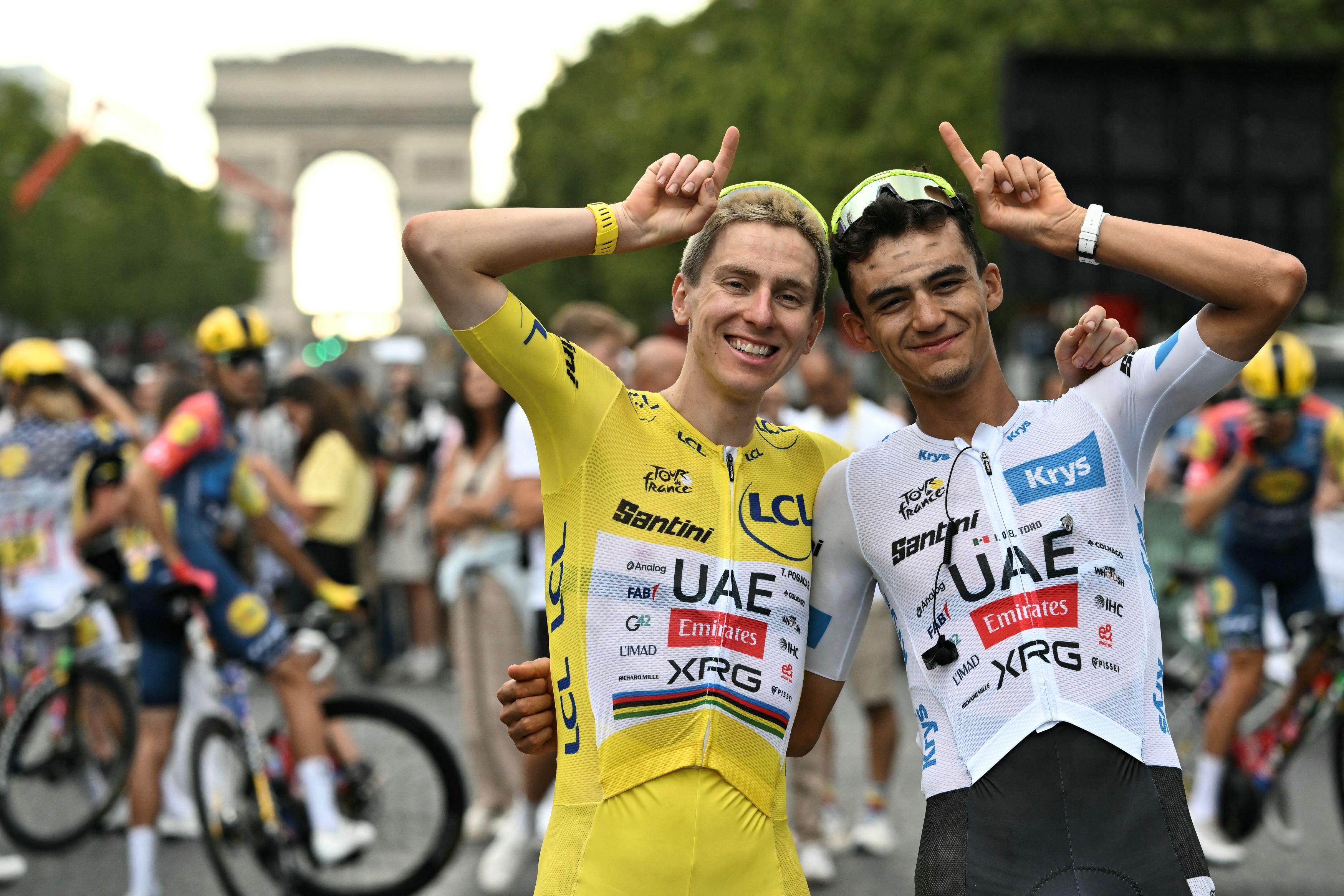UAE Team Emirates - XRG's Slovenian rider Tadej Pogacar celebrates his overall victory with UAE Team Emirates - XRG's Mexican rider Isaac Del Toro (R) after the 21st stage of the 113th edition of the Tour de France cycling race, 88,7 km starting and finishing in Paris, on July 26, 2026. (Photo by Jeff PACHOUD / AFP via Getty Images)