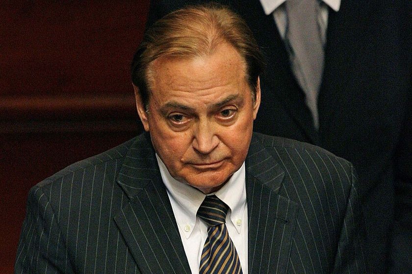A man in a suit looking serious.