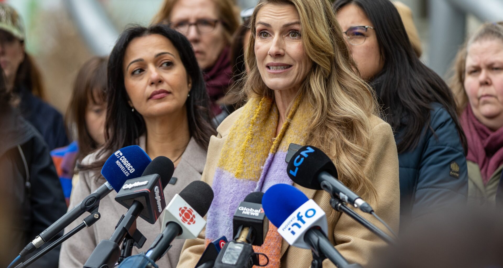 Ingrid Falaise speaks at a press conference calling on measures to prevent femicides, as others including Québec solidaire co-spokesperson Ruba Ghazal listen.