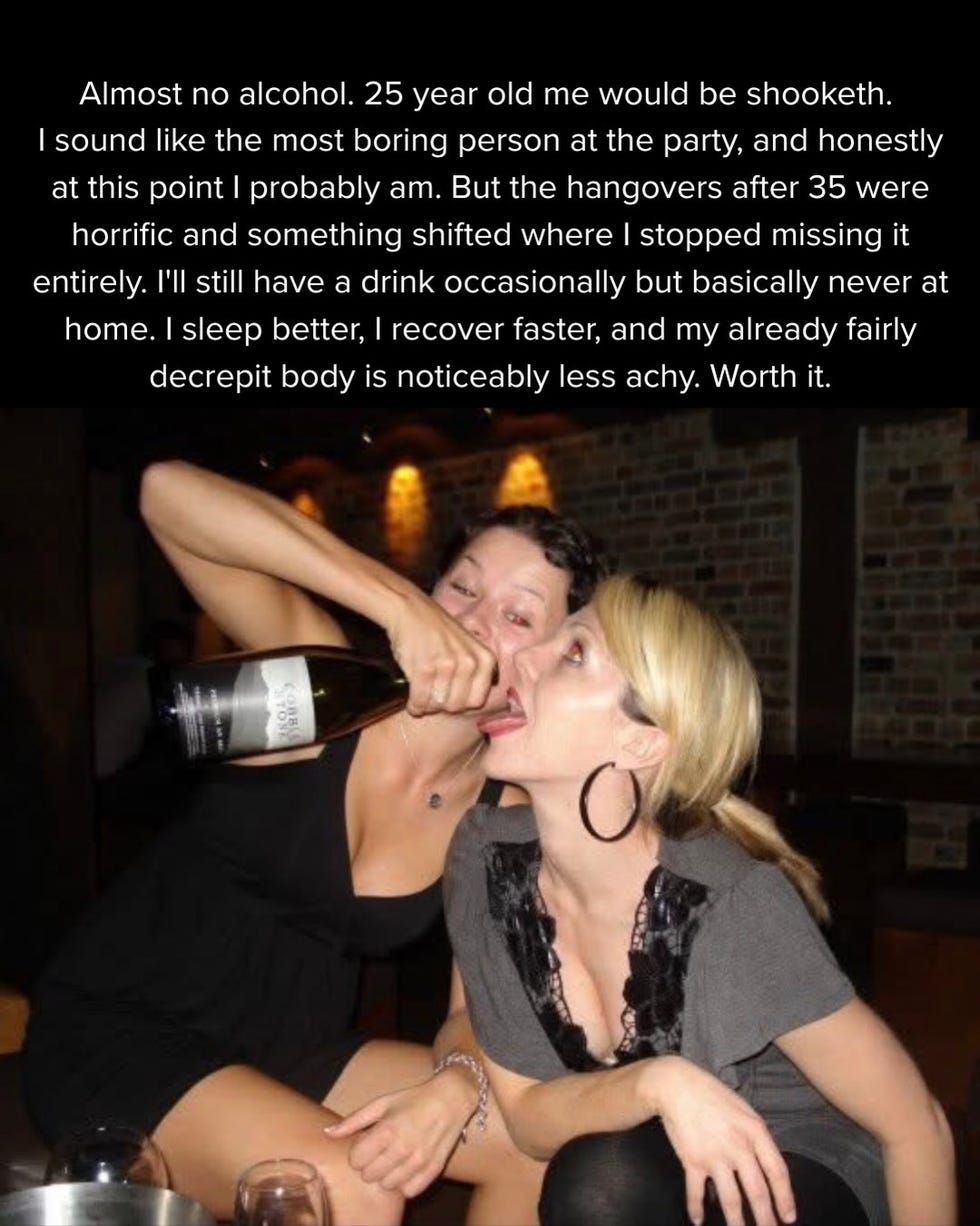 two people at a party with one pouring champagne into the other's mouth. two people at a party with one pouring champagne into the other's mouth.