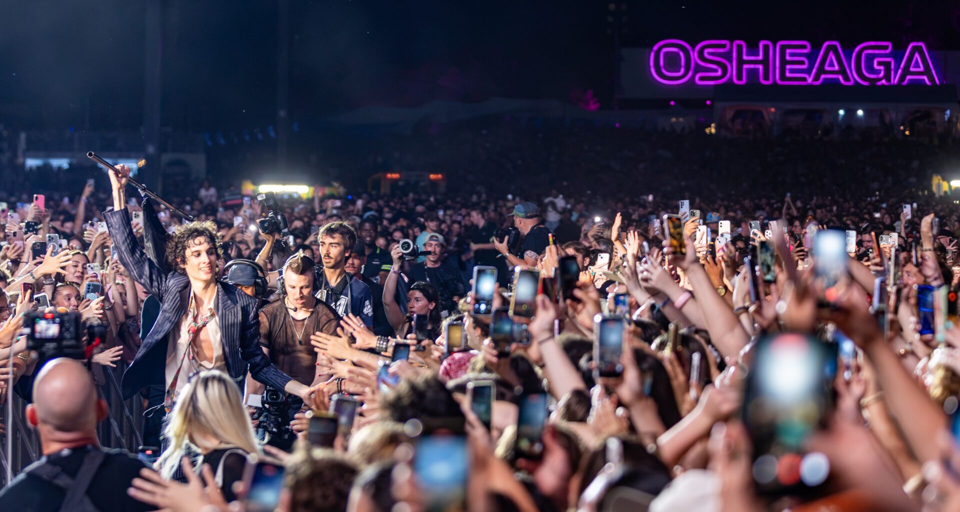 Sombr performs from a walkway through the crowd at the Osheaga Music and Arts Festival