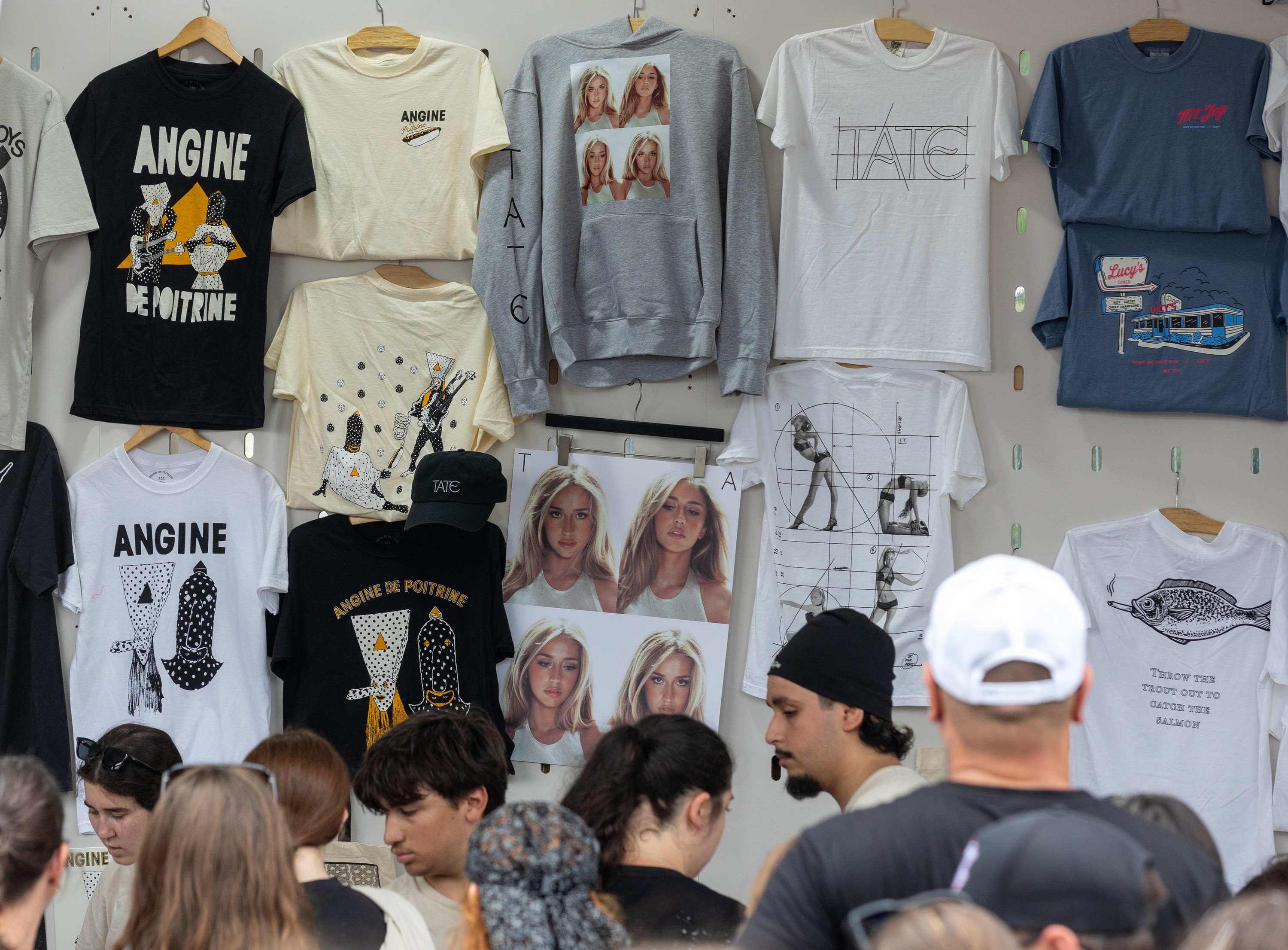 Angine de Poitrine and Tate McRae merchandise on sale at the Osheaga Music and Arts Festival