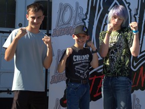 Three young fighters posing for a photograph
