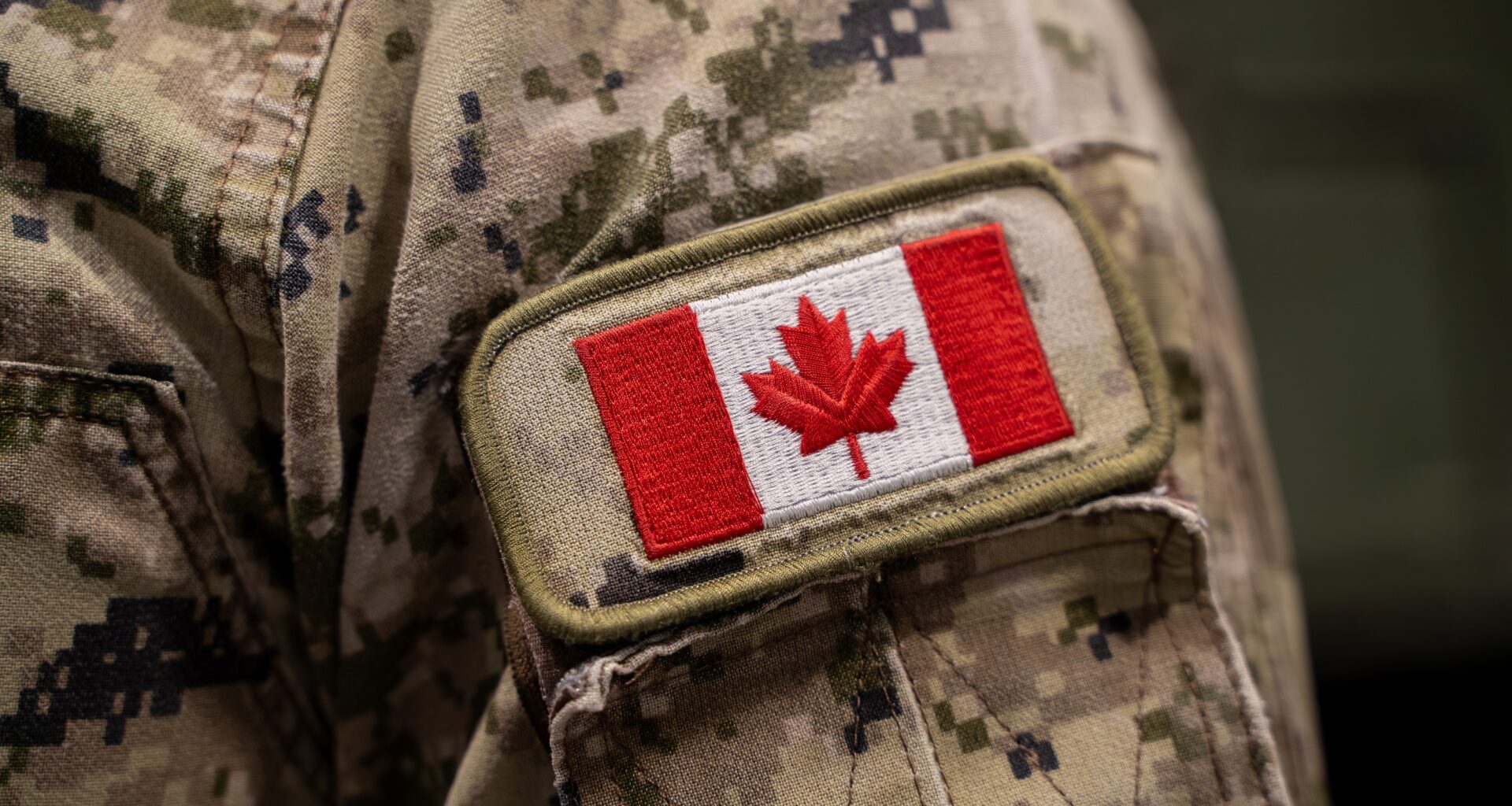 Close up of Canadian flag patch on military uniform.