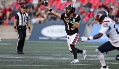 A game official keeps a close eye on the action as Redbalcks QB Jake Maier eludes pressure from the Alouettes' Tyrice Beverette and throws the ball.