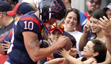 Alouettes quarterback Davis Alexander signs a ball for a young fan.