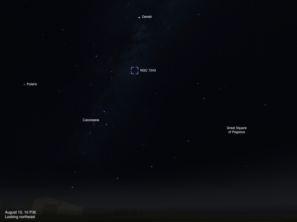 A sky chart showing the northeastern sky on August 10, 2026, at 10 P.M. The open star cluster NGC 7243 is highlighted with a dashed blue box near the center of the image. Deneb is labeled above it, Polaris to the left, Cassiopeia below and to the left, and the Great Square of Pegasus to the lower right. A faint band of the Milky Way is visible near the top of the image.