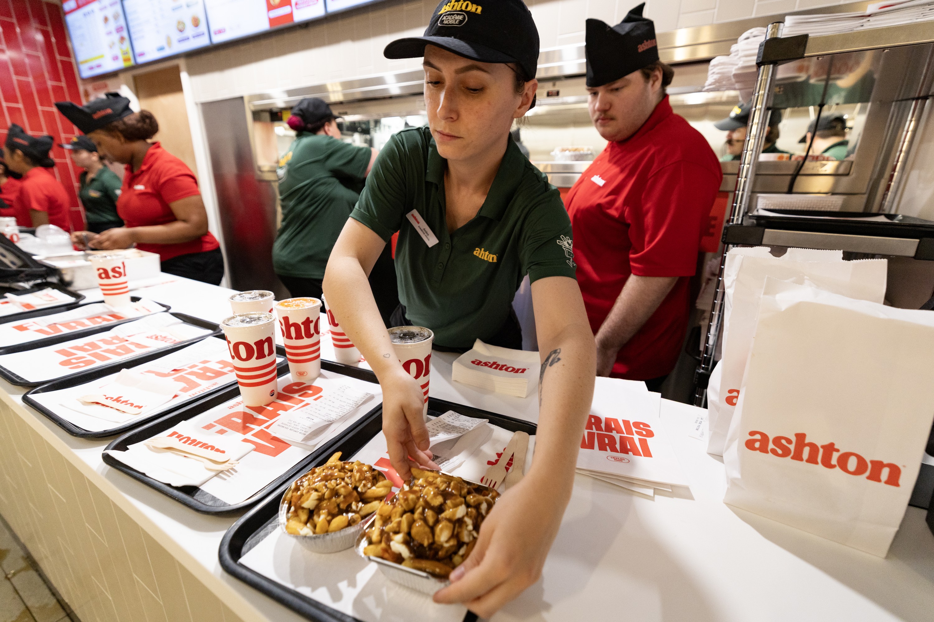 Servers prepare trays at the Ashton fast-food restaurant