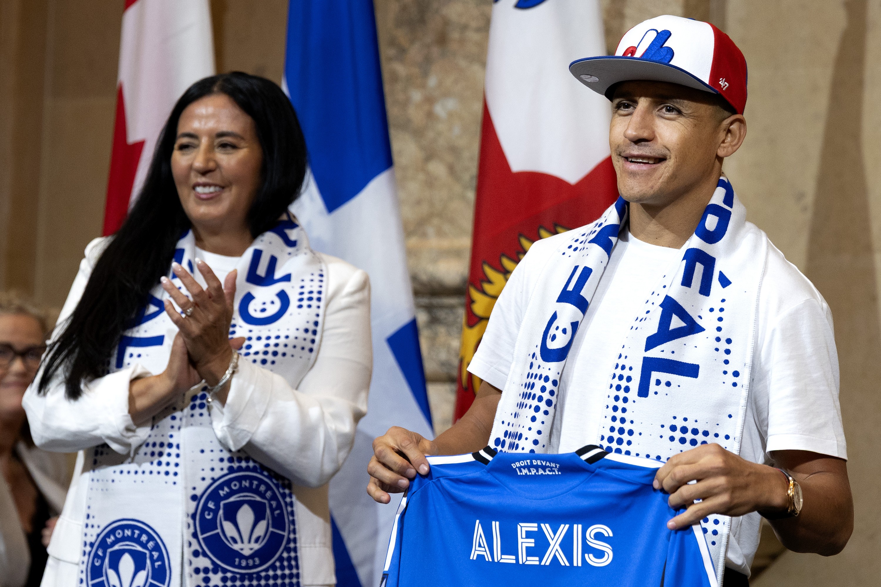 Alexis Sánchez, a Chilean soccer star who just signed with CF Montréal, sports a Montreal Expos hat gifted to him by the mayor after signing the Golden Book with Mayor Soraya Martinez Ferrada in Montreal on Friday, August 14, 2026. 