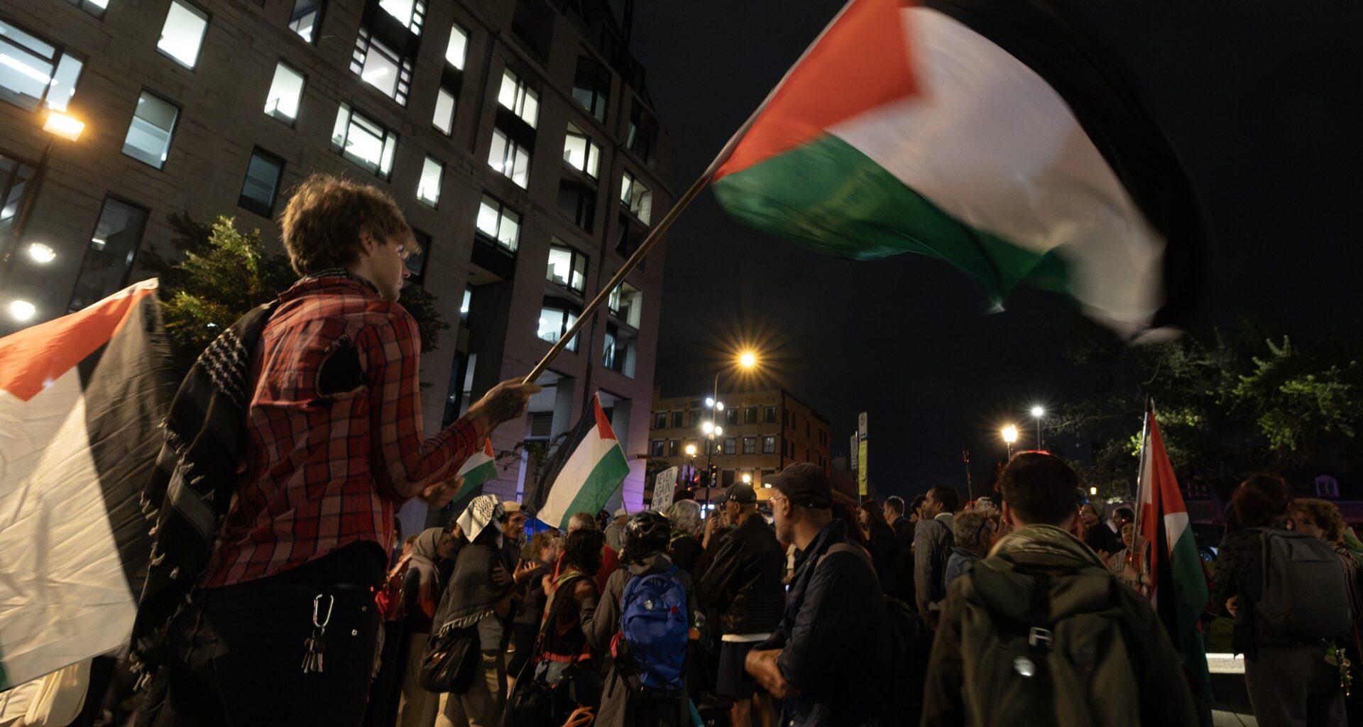 Pro-Palestinian protesters outside Montreal City Hall at night