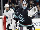 Chris Driedger #60 of the Seattle Kraken controls the puck against the San Jose Sharks during the third period at Climate Pledge Arena on April 29, 2022 in Seattle, Washington.