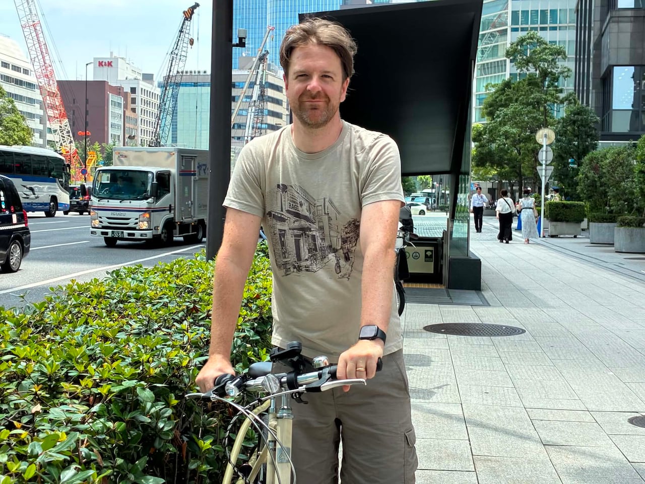 A smiling man and his bike.