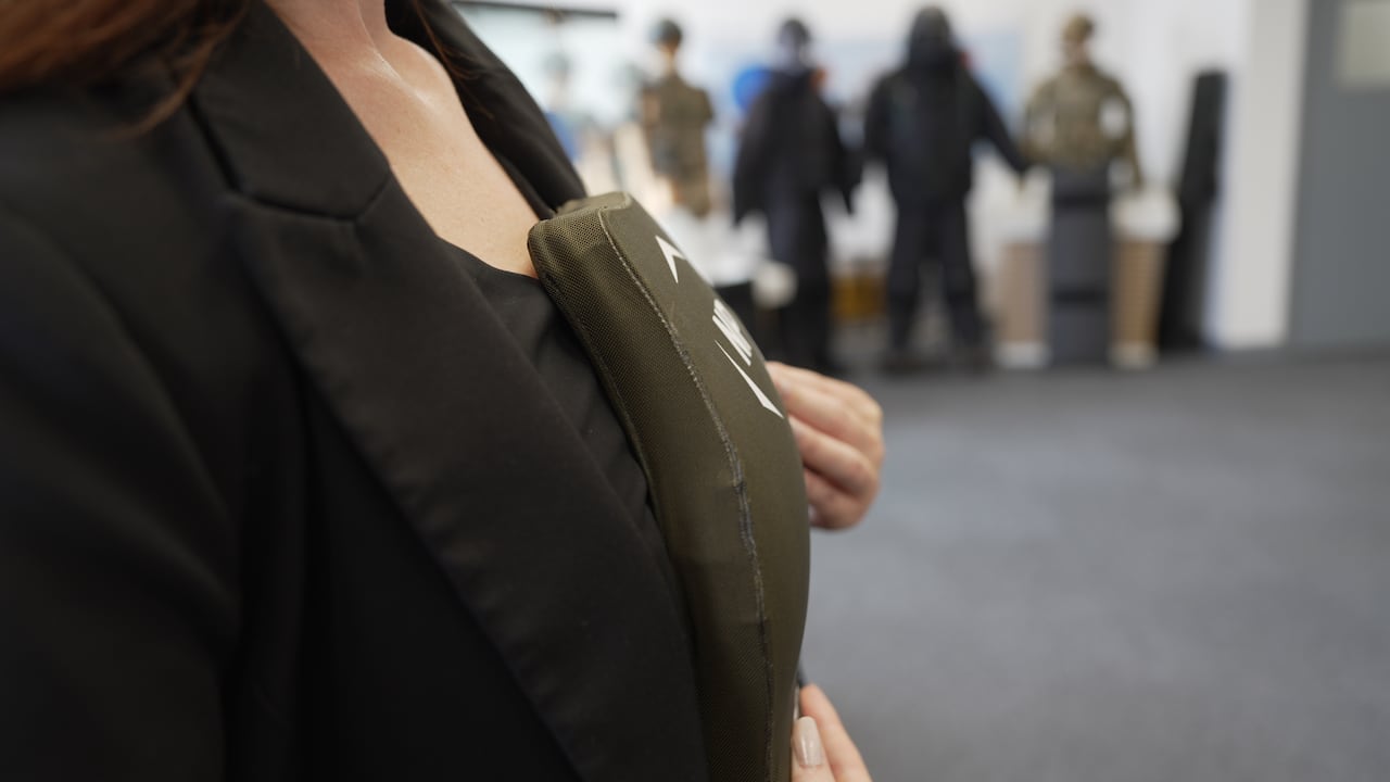 NP Aerospace's Erin Grieve shows how her company's curved ballistic plates are shaped to fit a woman's chest so it's tighter and there isn't a gap exposing vital organs.