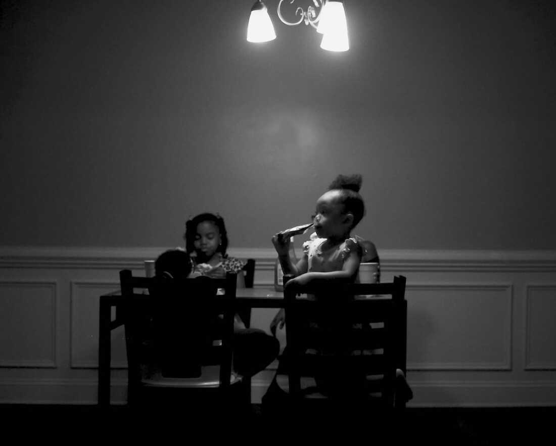 Stevens’ nieces play games at the dining room table while waiting for dinner.