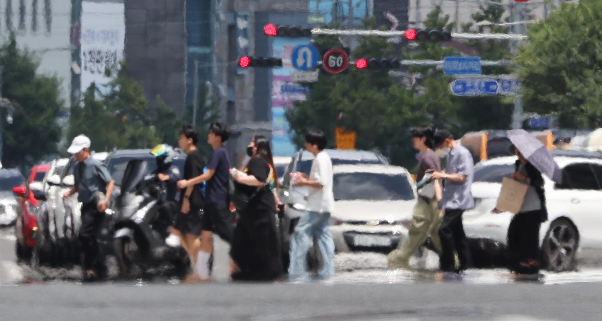 Heat shimmer rises from a road surface in Nam District, Ulsan, July 23, as intense ground heat distorts the air. Yonhap