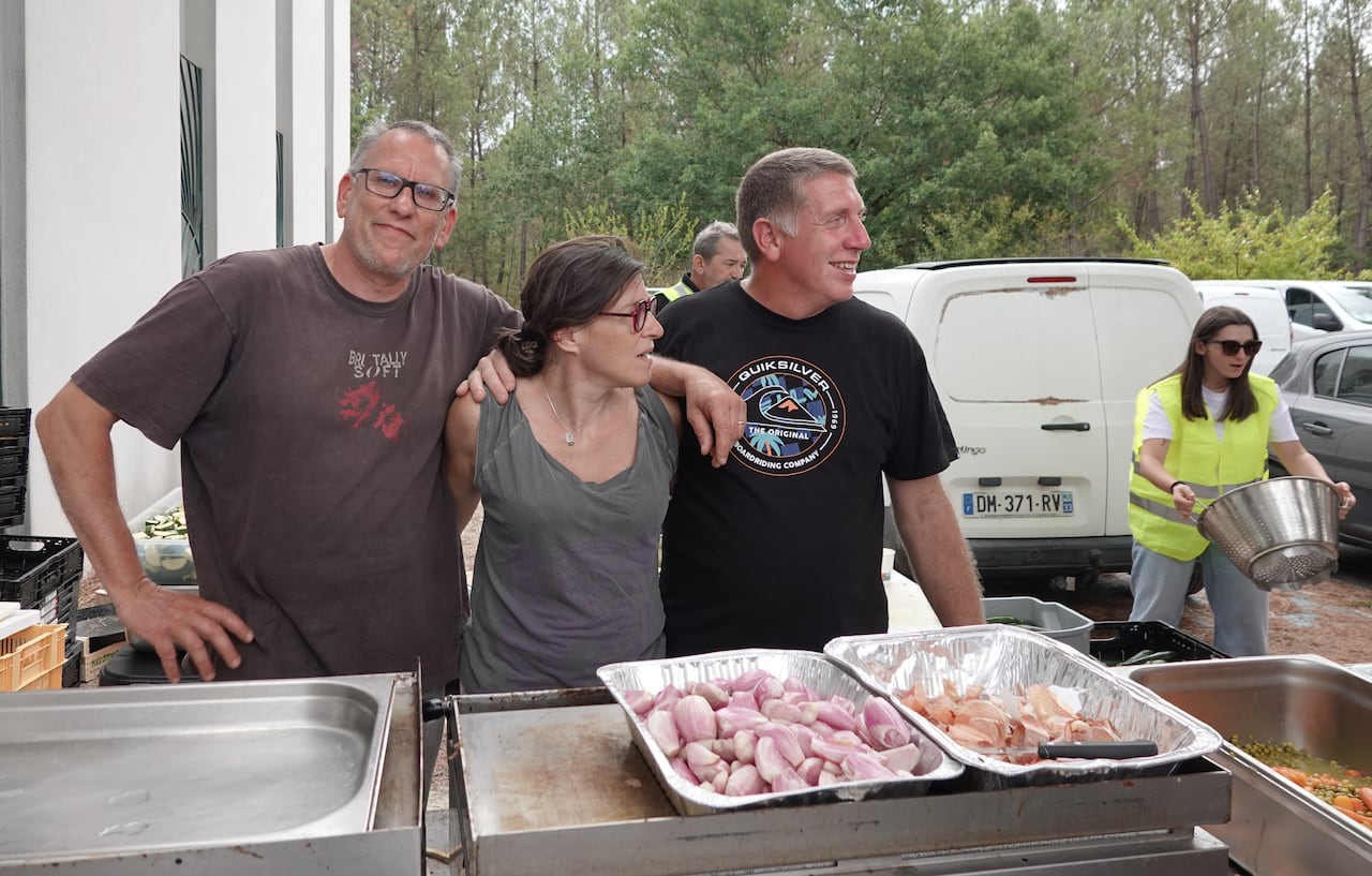 Frédéric Delbreil, Pascale Sirieix and Maxime Frère, who work and own restaurants in the Gironde region of France, which has been battling intense wildfires, volunteer in Saint-Jean-d'Illac on Friday.