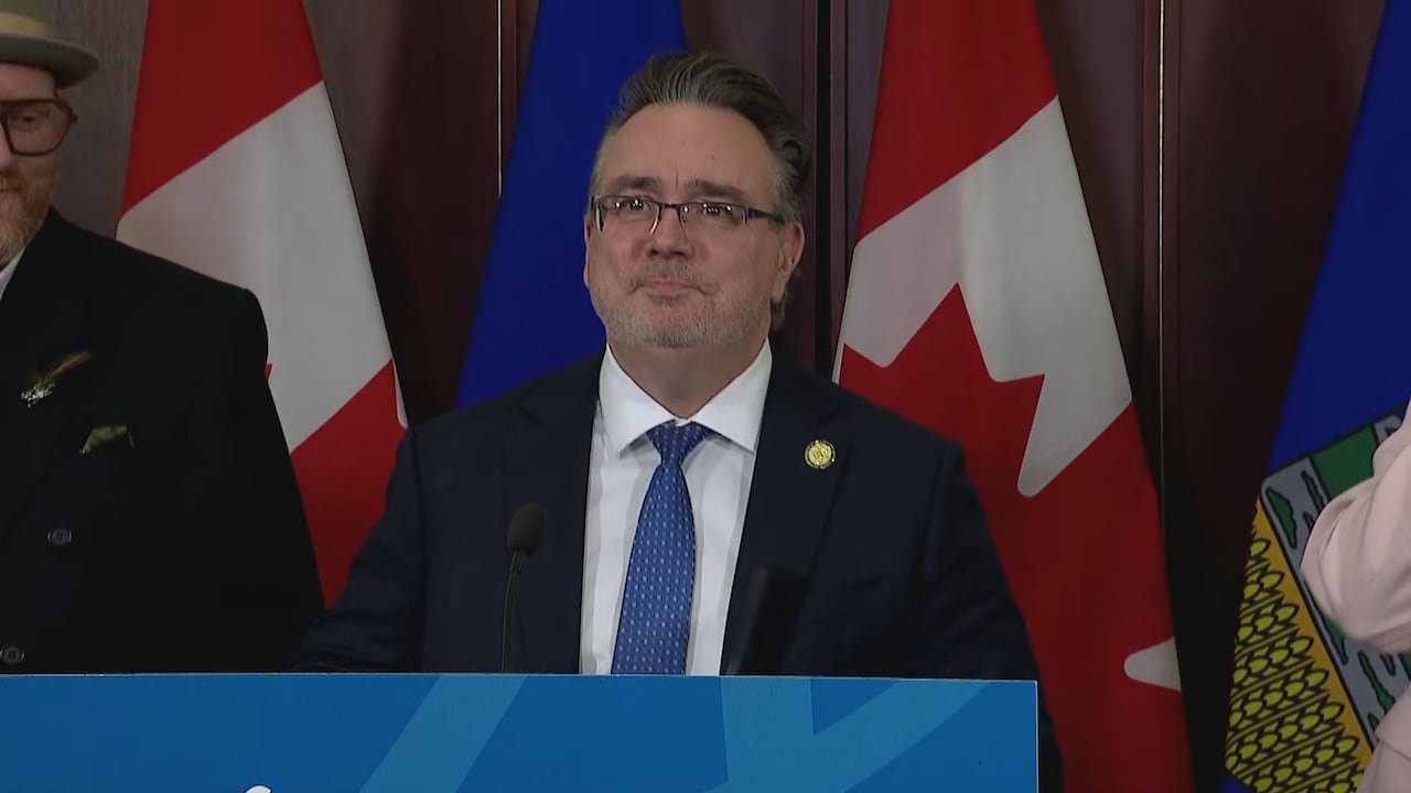 A man stands behind a podium.