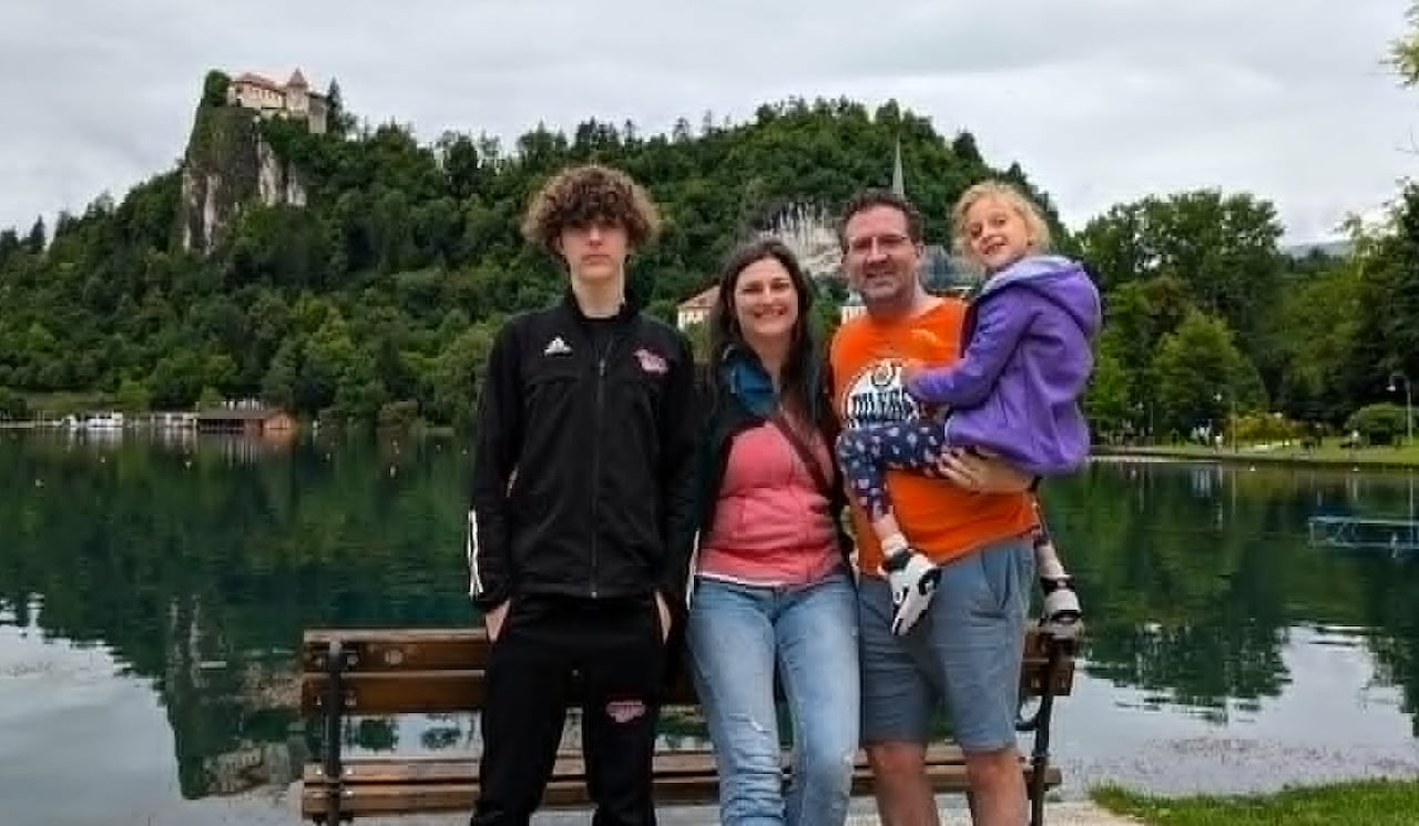 A family poses for a photo while on vacation.