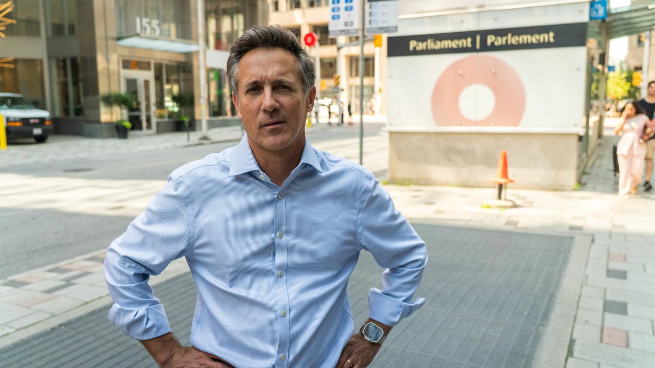 Man in blue shirt outside OC Transpo station