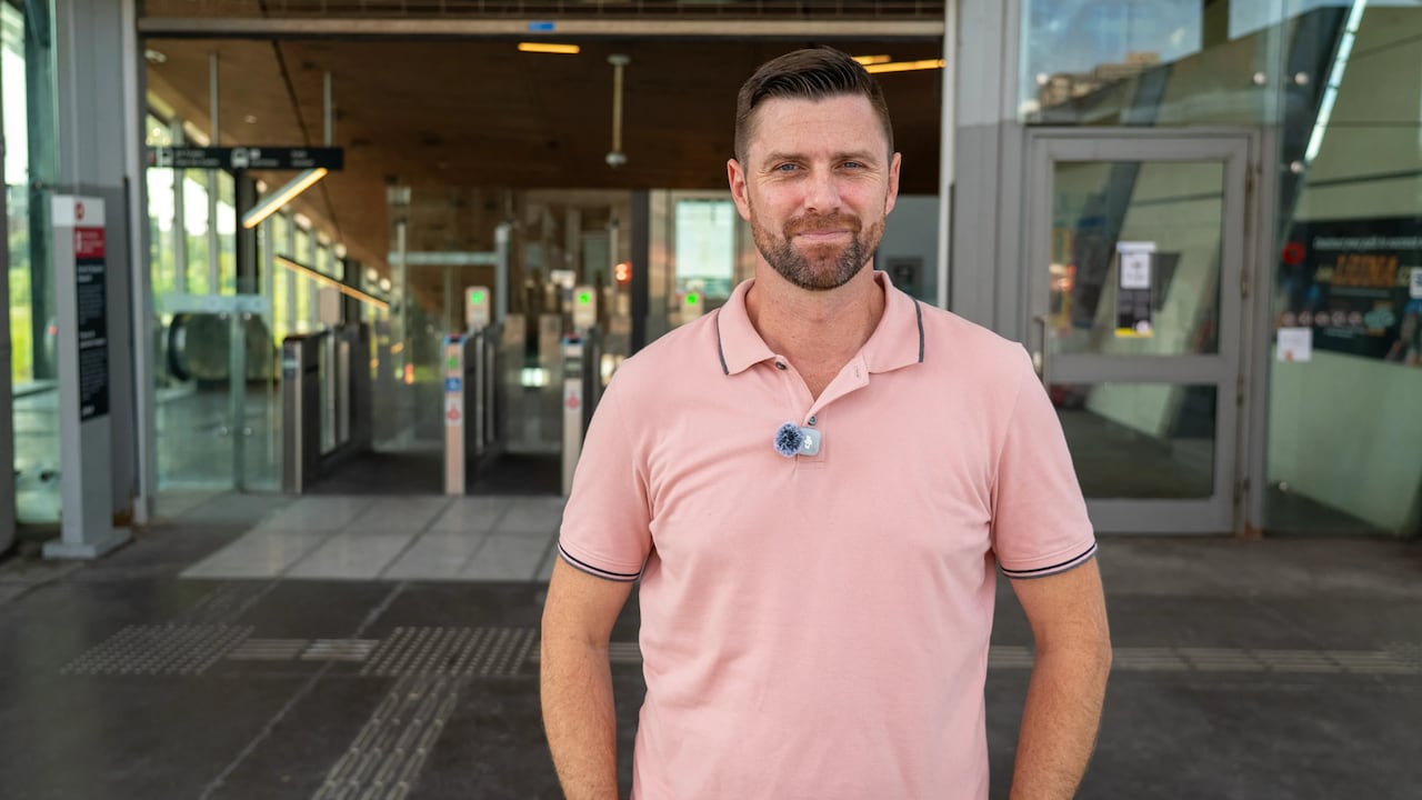 Man in pink shirt at OC Transpo station